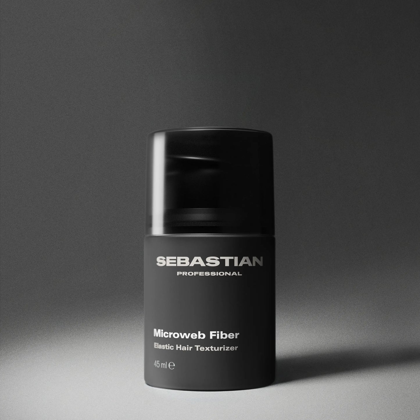 Black container of Sebastian Professional Microweb Fiber on a gray background