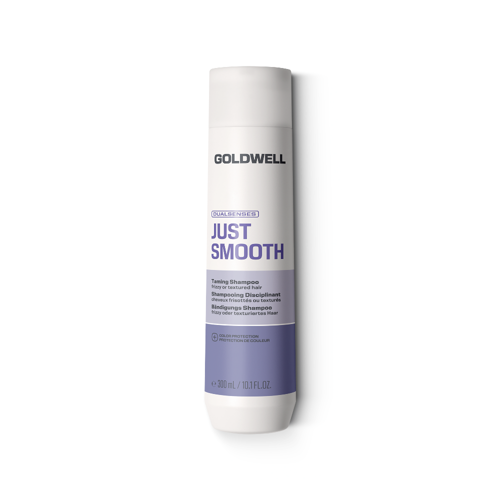 A bottle of Goldwell Just Smooth Taming Shine shampoo on a solid white background.