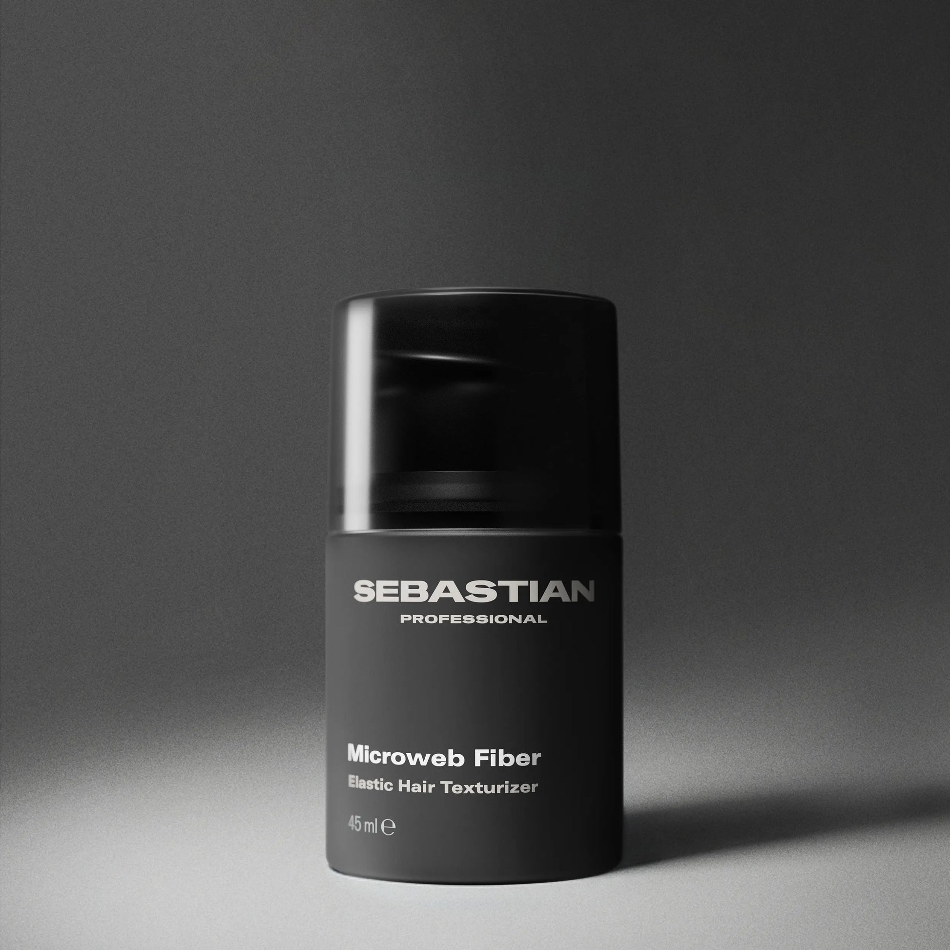 Black container of Sebastian Professional Microweb Fiber on a gray background